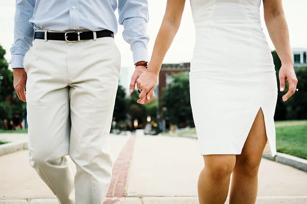 Couple holding hands, symbolizing connection and intimacy in relationships